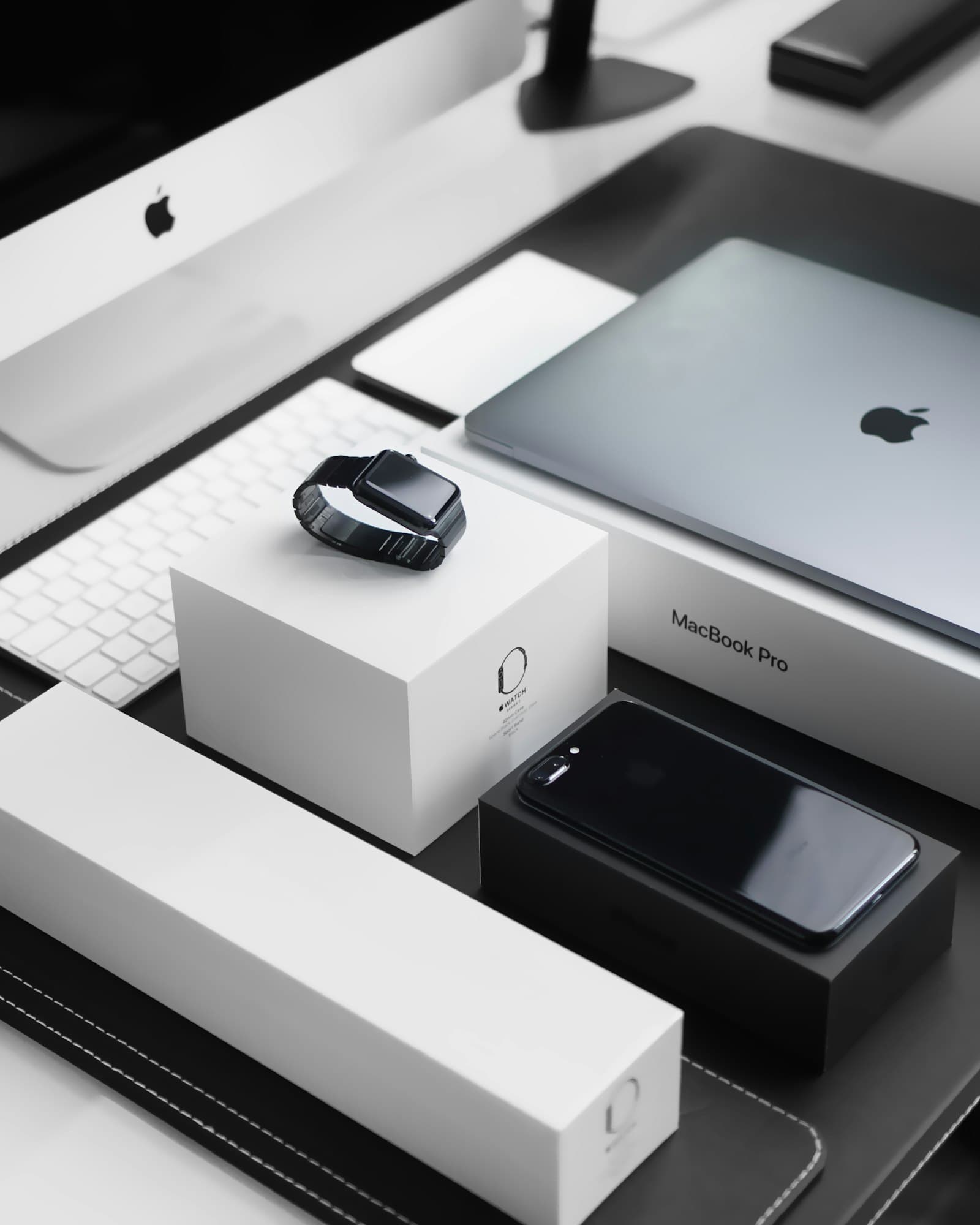 Assorted Apple devices and boxes arranged on a desk